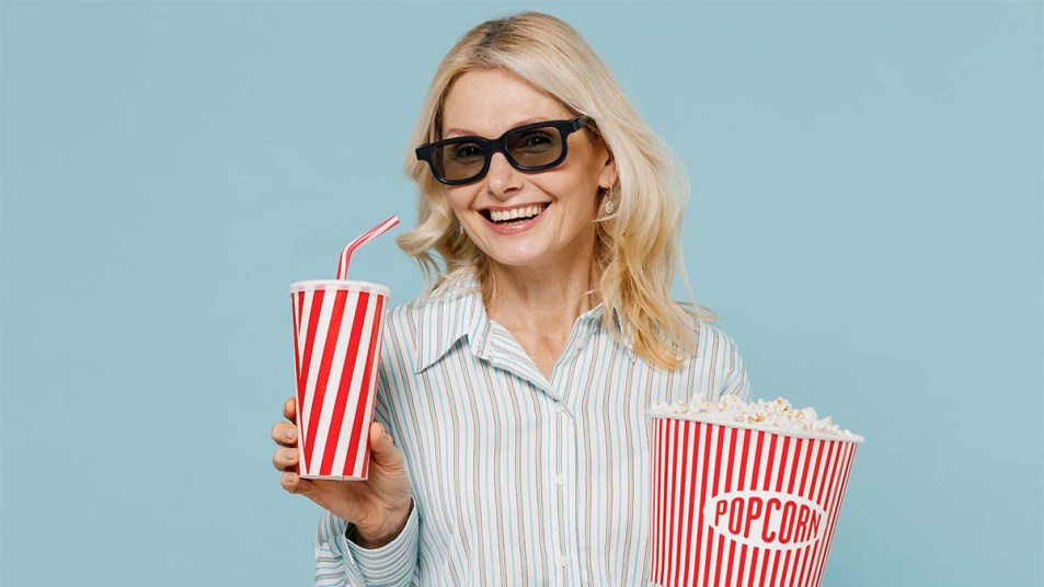 Happy-woman-wearing-3D-glasses-watch-movie-film-hold-bucket-of-popcorn-and-cup-of-soda