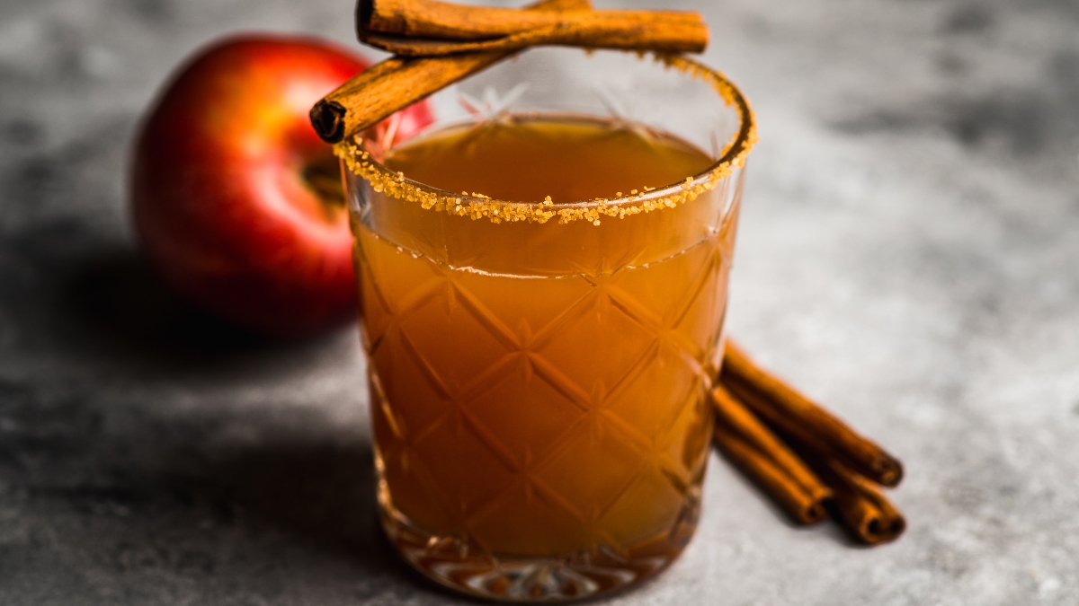 apple cinnamon hard seltzer in a clear glass