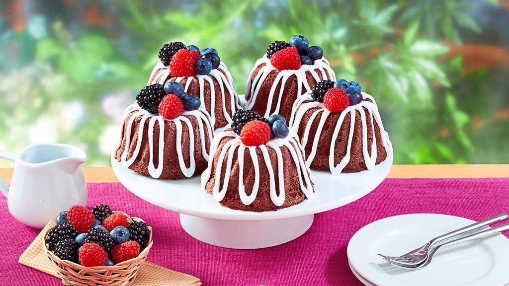 Berry-Fudge Mini Bundt Cakes sits on a pink tablecloth (Mini bundt cake recipes)