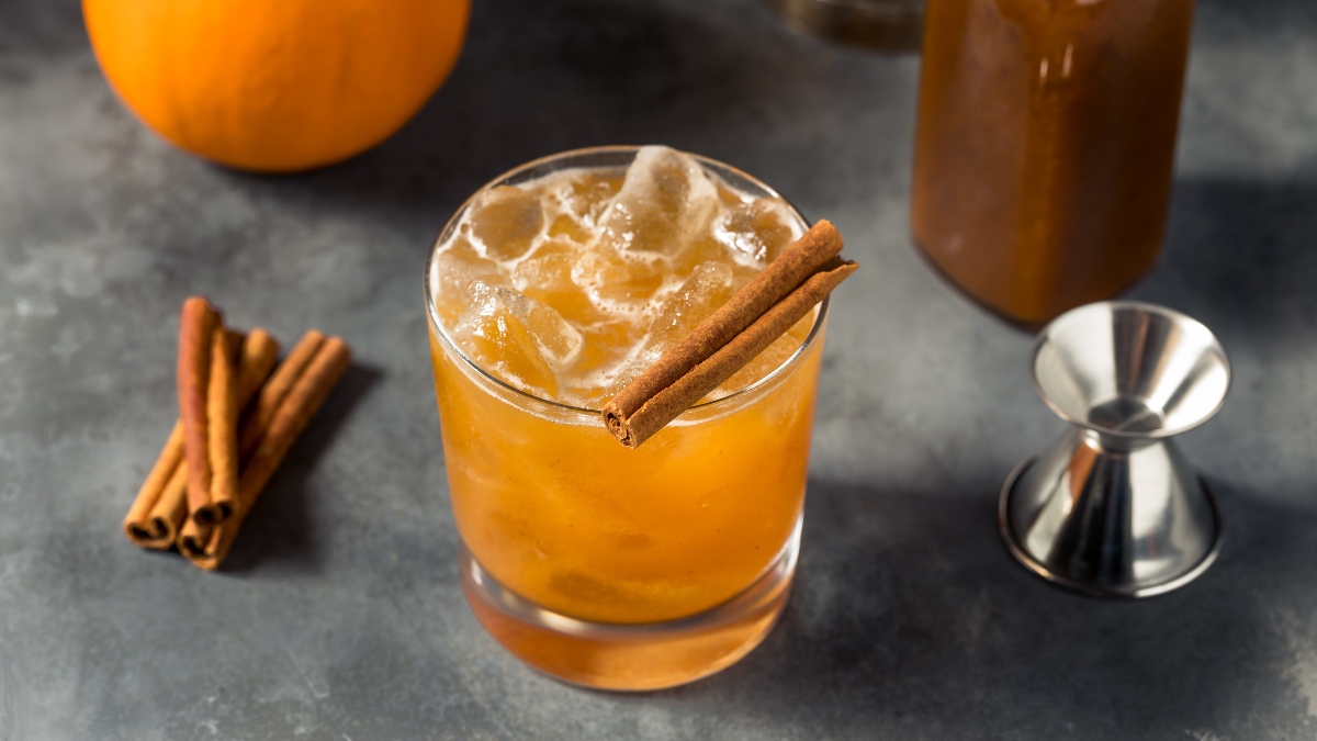 pumpkin spice hard seltzer with cinnamon stick in glass
