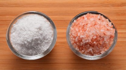 table salt and pink salt in two glass containers, concept for salt alternatives