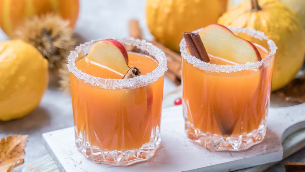 Pumpkin punch or sangria in a glass with apple, cinnamon