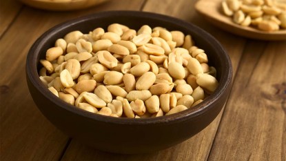 Roasted peeled unsalted peanuts in rustic bowl