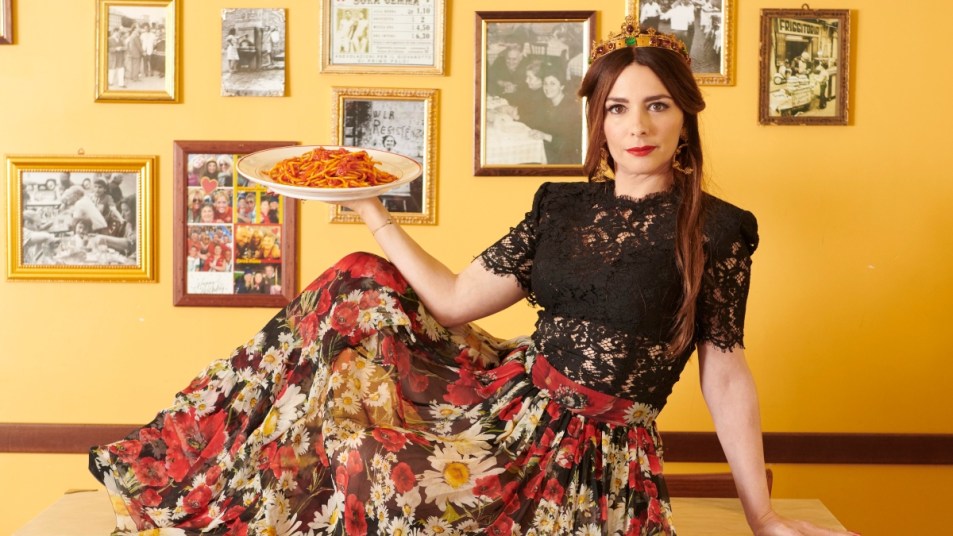 Nadia Munno in a crown holding plate of pasta
