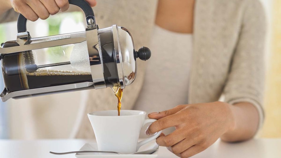 Woman pouring French press coffee