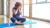 mature woman exercising on yoga mat sitting, covering face, bladder leaks concept