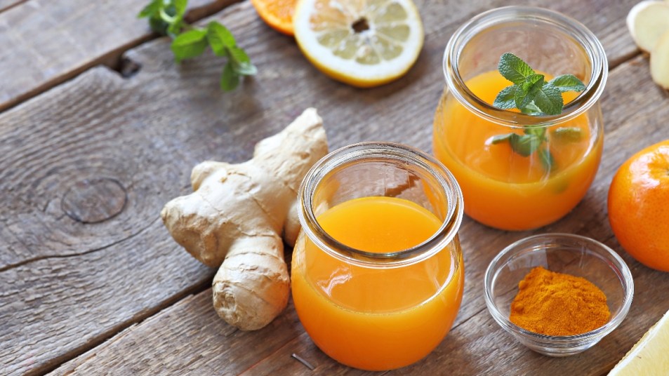 wellness shots made with turmeric, orange, and ginger on a table