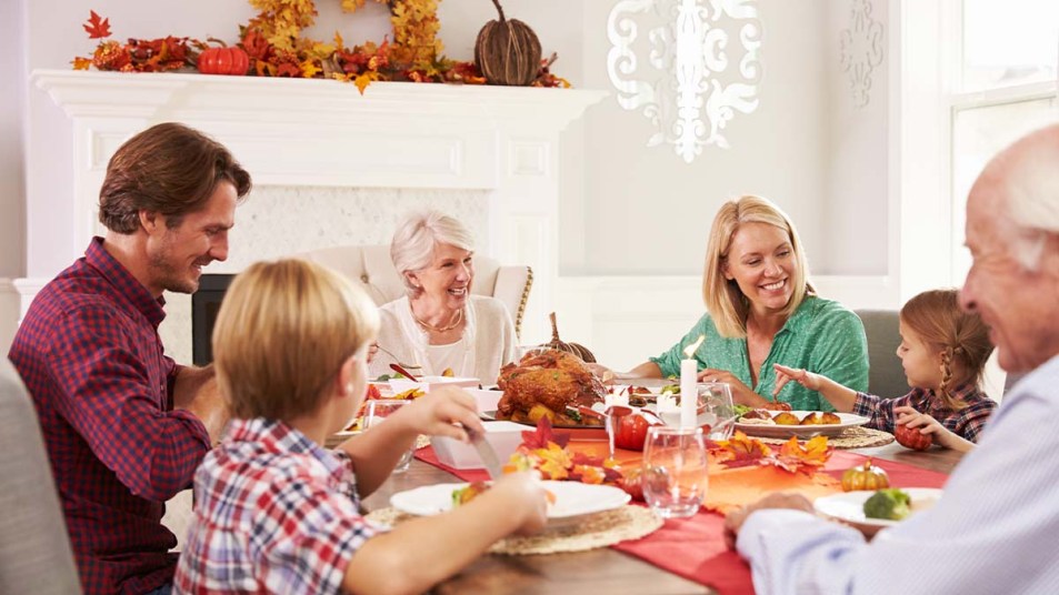 Family with grandparents enjoying Thanksgiving meal at table