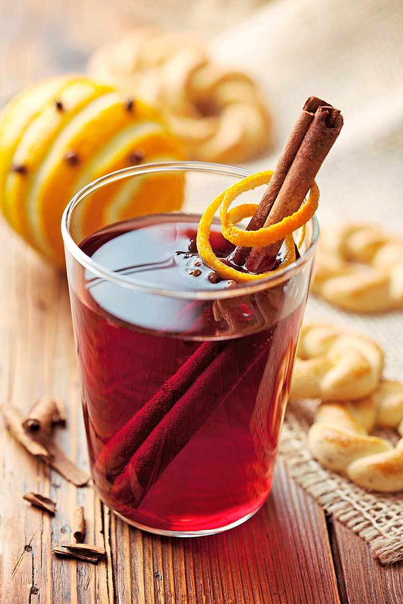 mulled red wine in a glass with cinnamon sticks