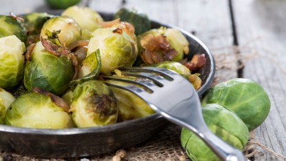 cooked brussels sprouts with ham and onions, concept for fall vegetables
