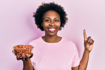 woman holding peanuts and smiling