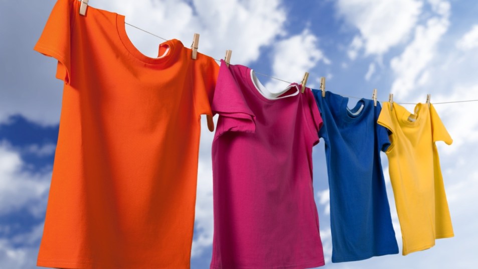 Colorful shirts free of oil stains being hung out to dry