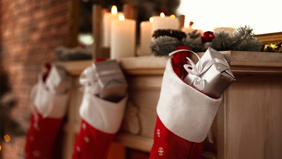 Decorative fireplace with Christmas stocking and gifts