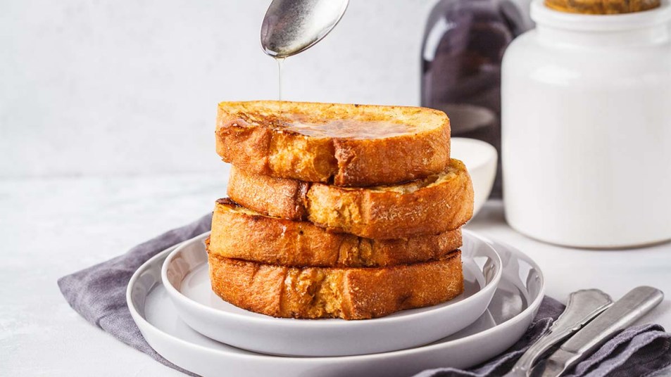 Slices of French toast on a plate with syrup