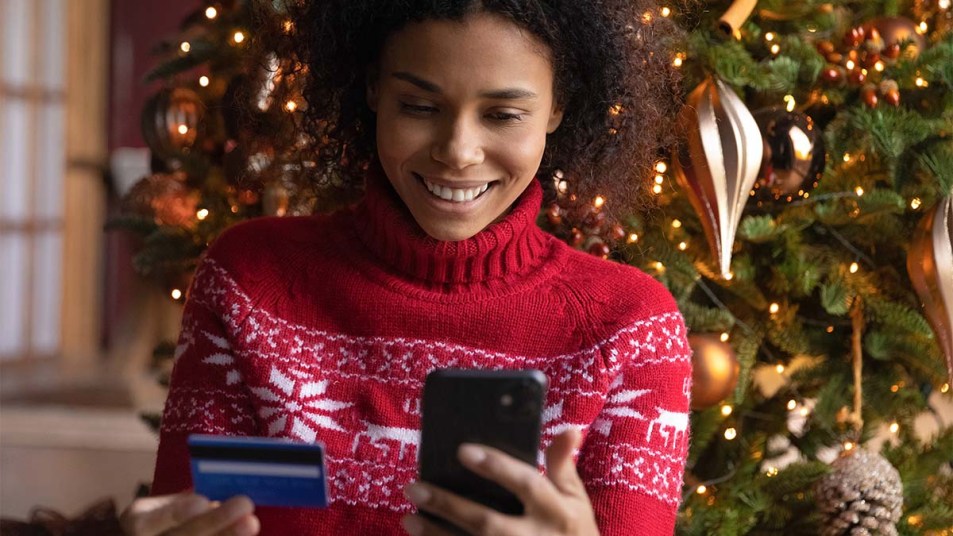 Woman paying online by credit card for Christmas gifts
