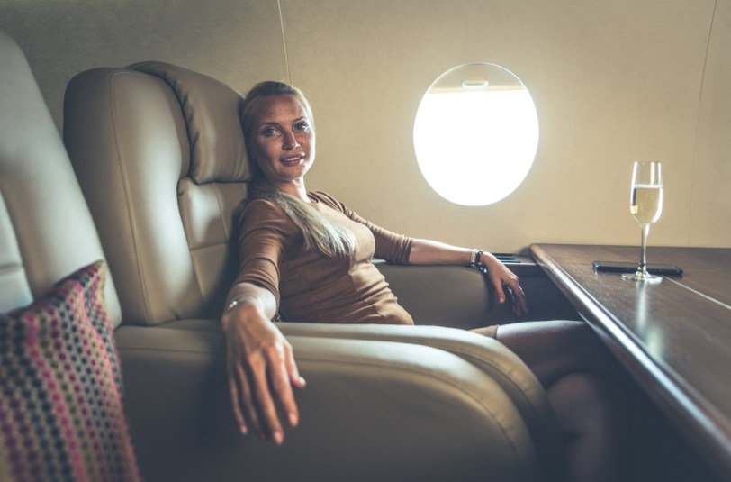 Wealthy woman smiling on a private jet