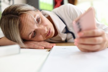 Tired woman with her head resting on table