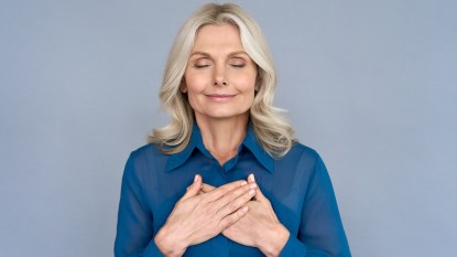Woman meditating with hands on chest