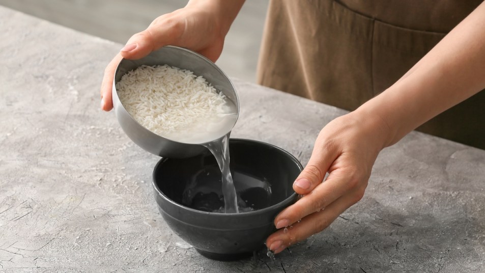 Woman preparing bowl of rice water