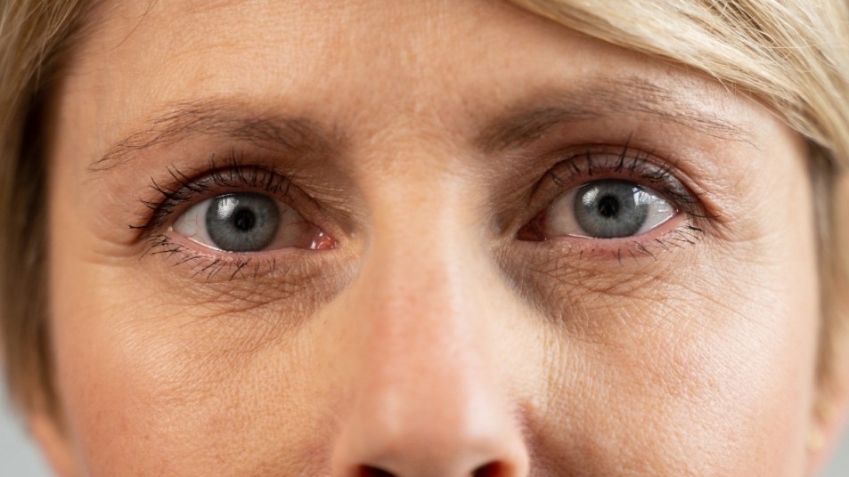 A 50-year-old middle-aged woman looks into the camera, anti-aging skin care, beauty, plastic surgery, cosmetic procedures. Close-up of the face