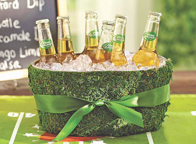 Beer bottles in green turf-covered cooler