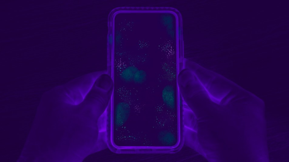 black light of hands holding a phone contaminated with allergens