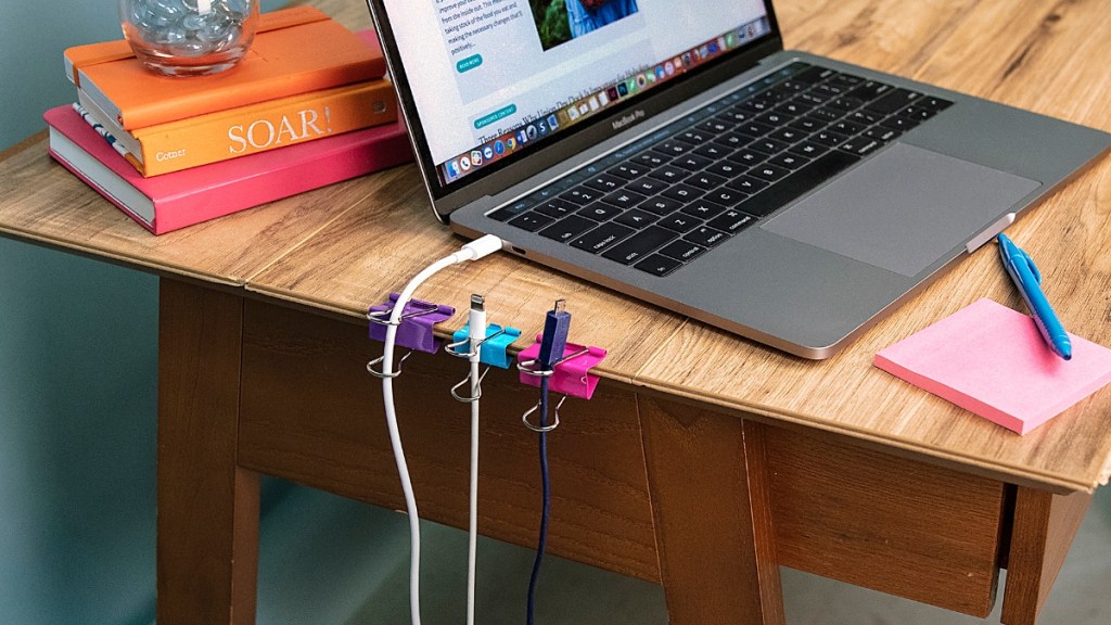 Binder clips keep cords organized on a desk