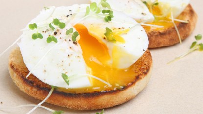 Poached eggs cooked in the microwave on top of toasted English muffins