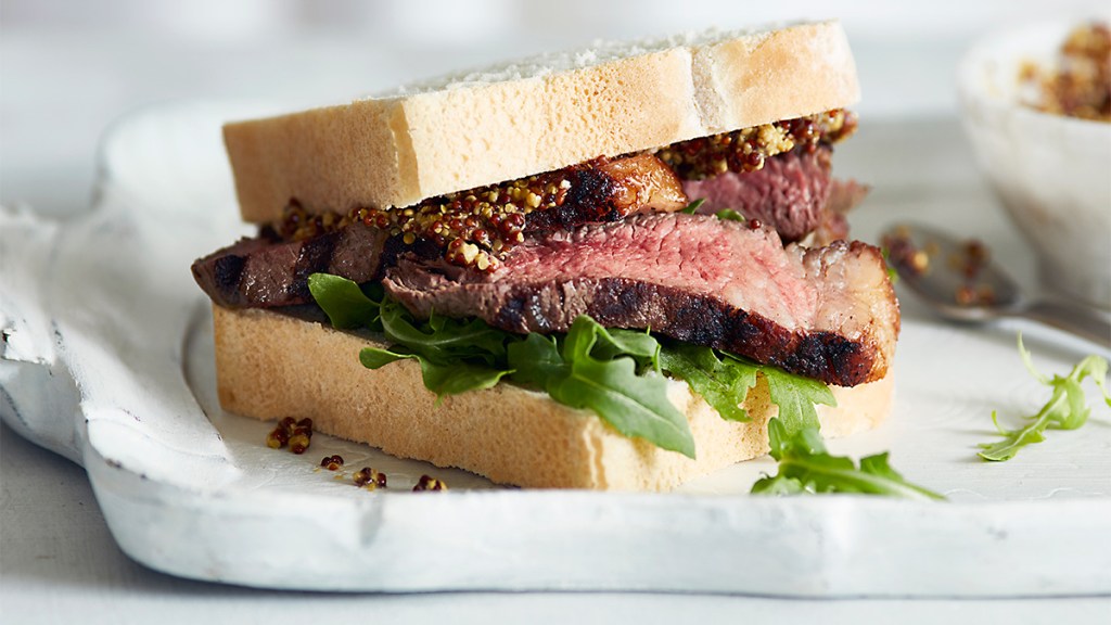 Steak sandwich layered with a quick version of homemade caramelized onions