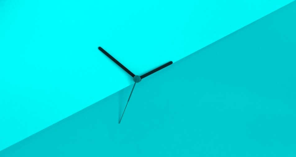 Daylight saving time concept. Clock hands on a blue background.