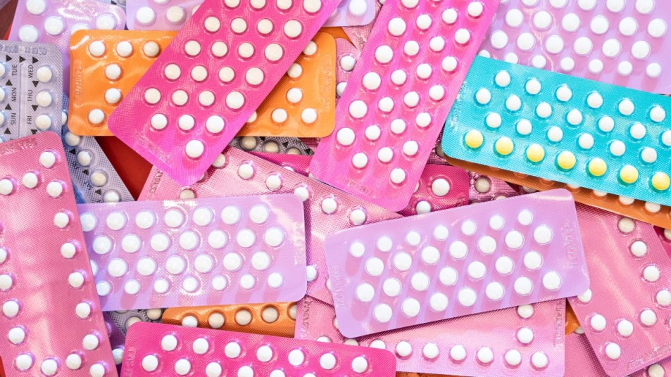 Pile of birth control pills in colorful pill packets