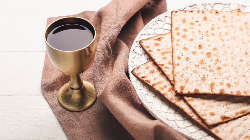 A cup of Kosher wine alongside matzo