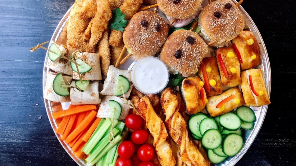 grazing platter for kids with vegetables and sandwiches