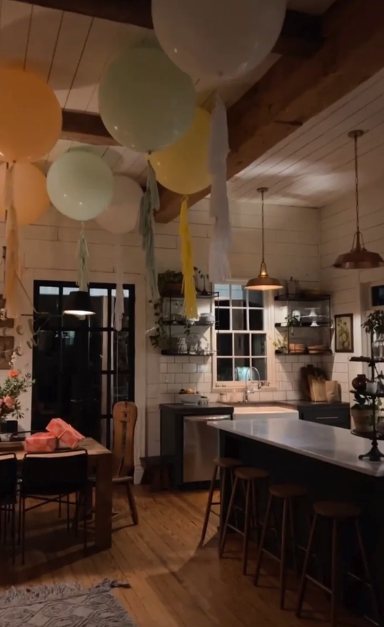 Chip and Joanna Gaines kitchen at night with balloons