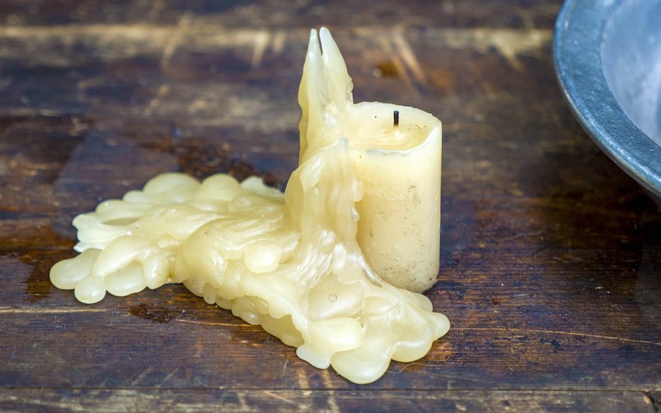 candle dripping wax on wood