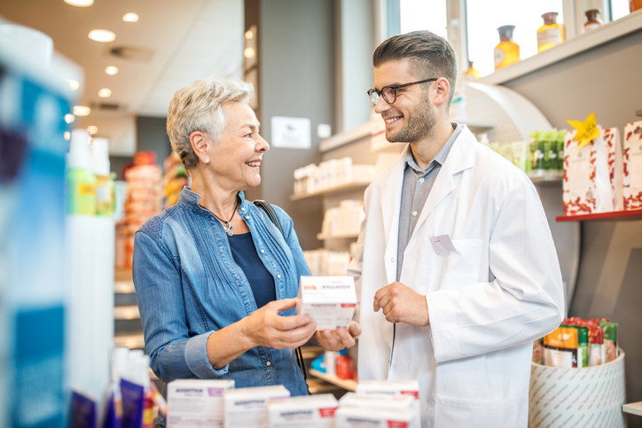 A woman smiles with her pharmacist after learning how to save on all your prescriptions