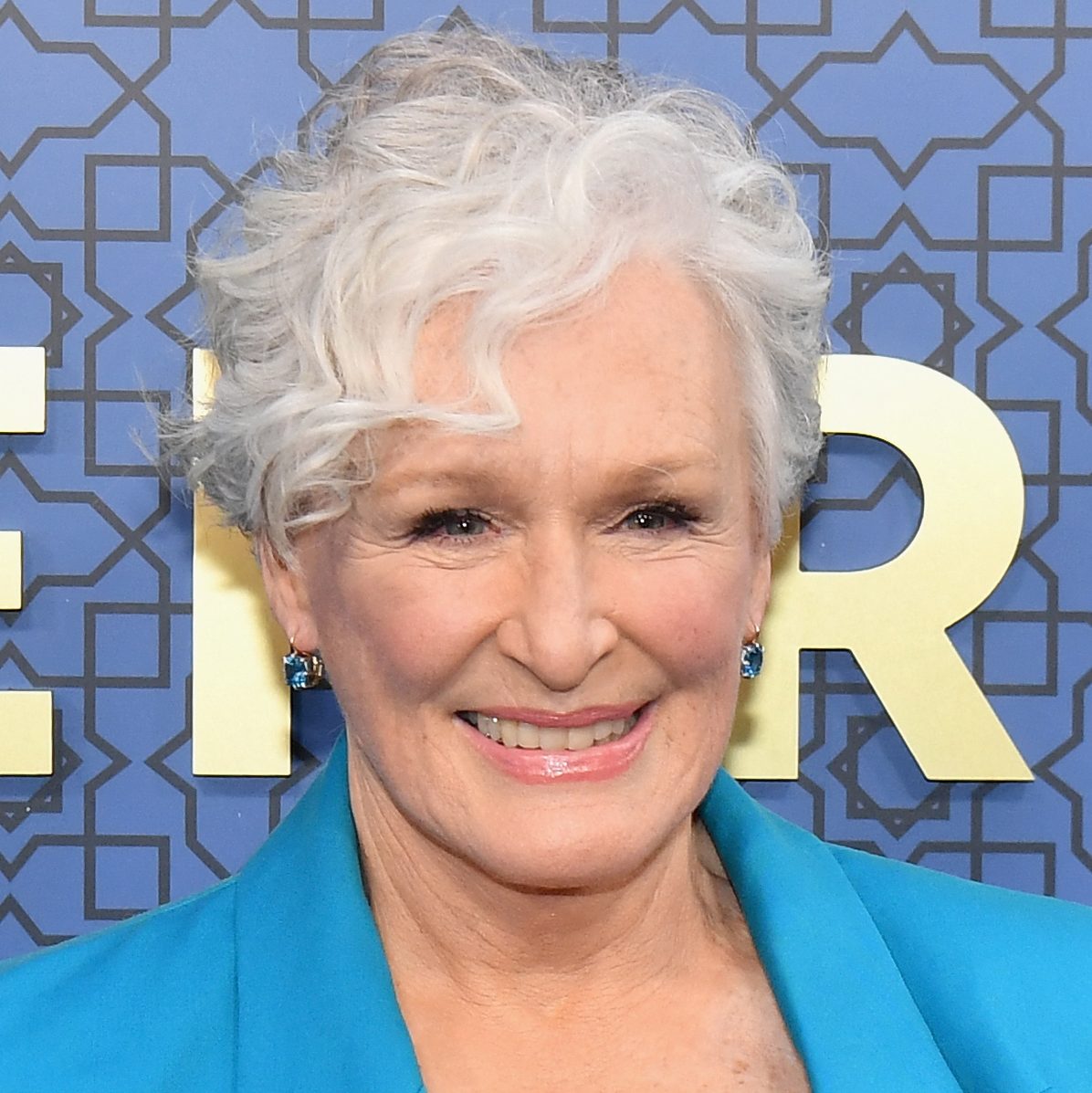 Glenn Close smiling and she has curly hair