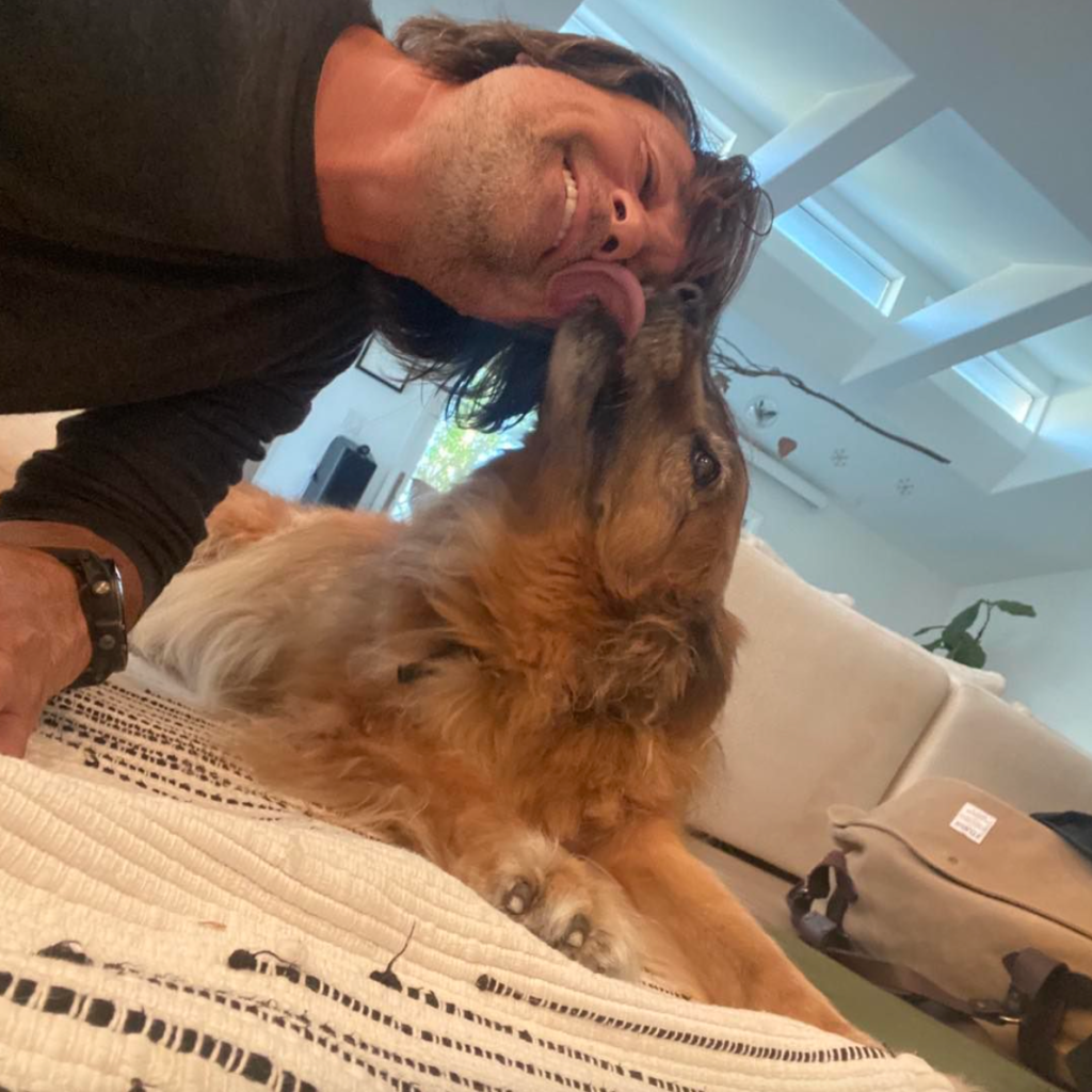 Martin Henderson poses with a photo of his dog, Sammy, in a photo posted to his Instagram movies and tv shows