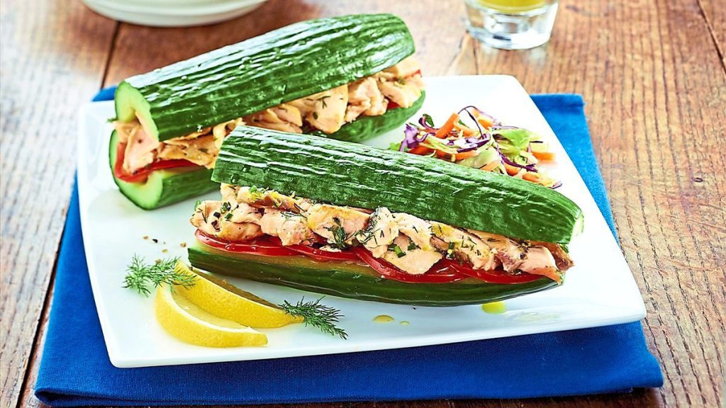 Tuna Salad Cucumber Boats sits on a wooden table looking great!