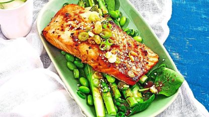 Teriyaki-Glazed Salmon with Vegetables sits on a blue table looking great