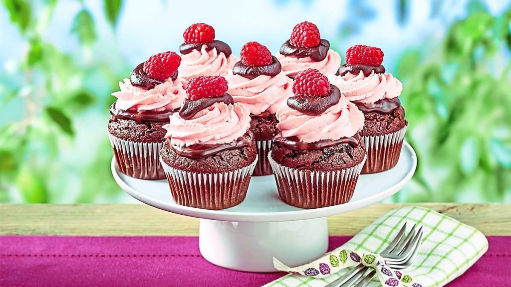 Raspberry Fudge Cupcakes sit on a plate waiting to be eaten
