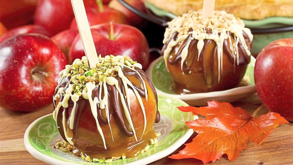 Chocolate-Drizzled Caramel Apples sit on a plate look delicious