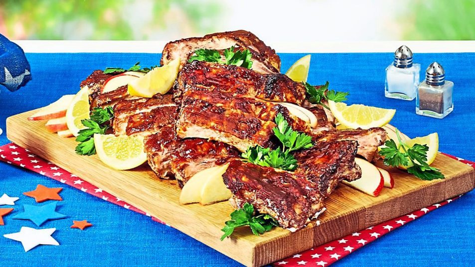 All-American Baby Back Ribs sit on a plate waiting to be eaten