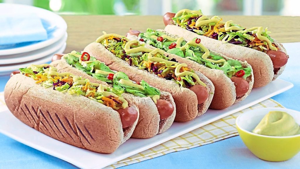 Loaded Hot Dogs sit on a plate waiting to be eaten