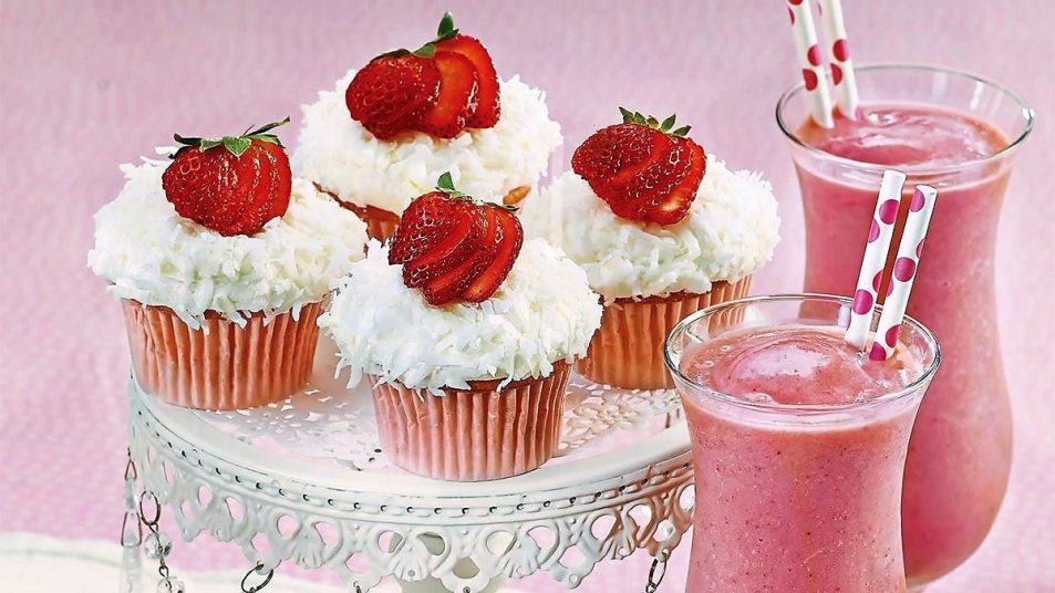 Strawberry Colada Cupcakes sits on a pink tablecloth (cocktail cupcakes)