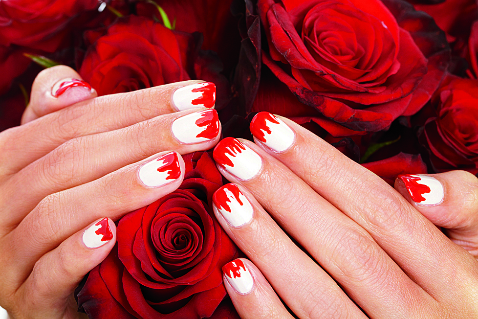 White and red vampire nails on rose background