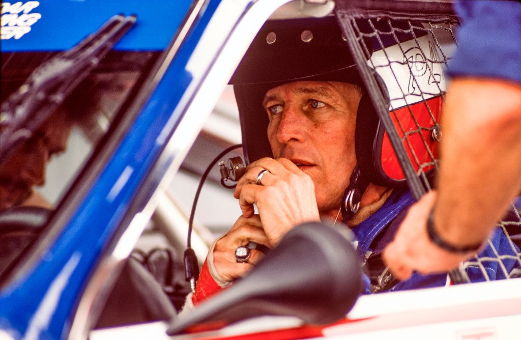 American actor and race car driver Paul Newman young  in his car during an inspection at Lime Rock Race Track, Lakeville, Connecticut