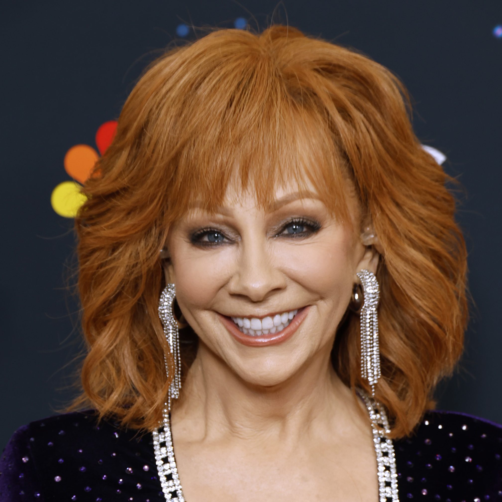 Reba McEntire with a shag haircut on shoulder length hair that shows how shag haircuts for women over 50 can be flattering
