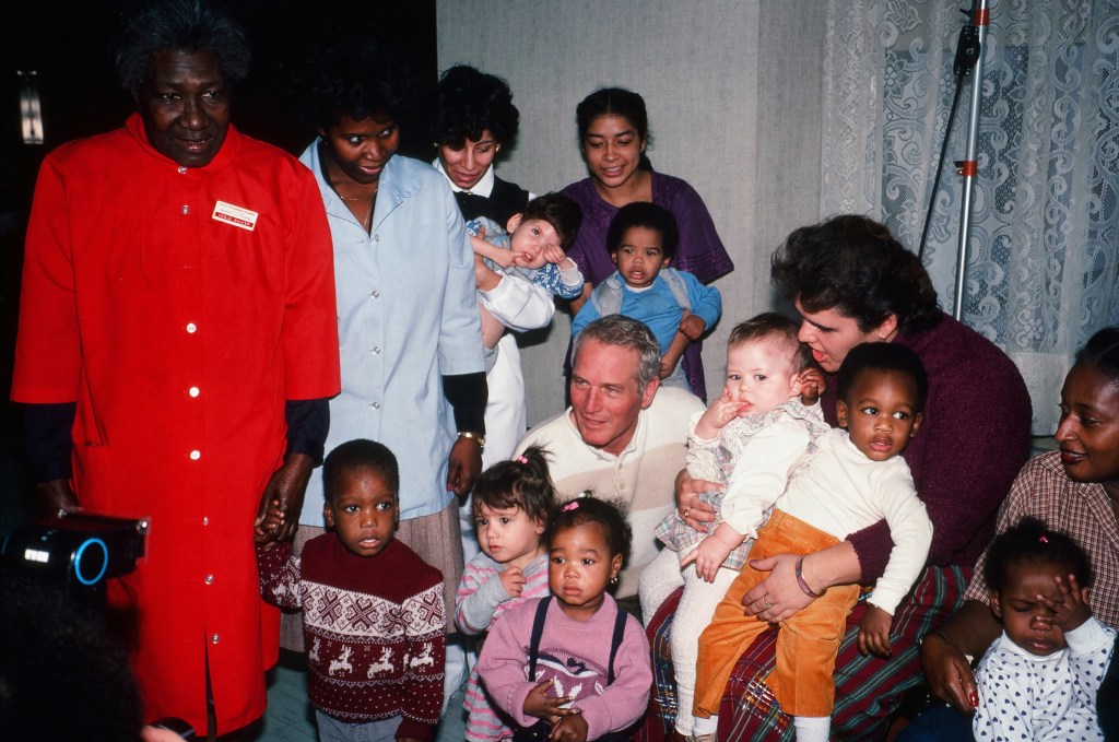 American actor, director, and philanthropist Paul Newman young (1925 - 2008) visits with children and staff at a houndling hospital, New York, New York, 1983