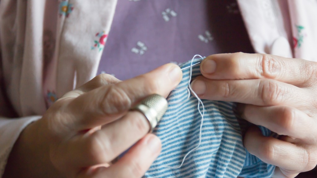 Woman hemming a dress using a needle and thread